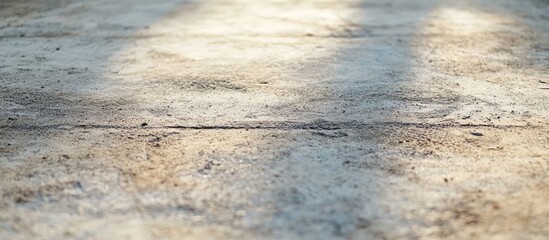 Fototapete - Newly poured cement sidewalk with a textured surface showing subtle sheen and natural light reflections in warm gray tones, with shadows accentuating depth.