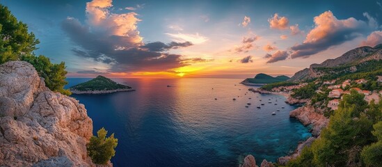 Aufkleber - Colorful sunset sky with vibrant clouds over tranquil sea, framed by rocky coastline and green trees, creating a stunning dusk atmosphere.