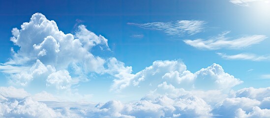 Poster - Serene blue sky with fluffy white clouds gently scattered across the horizon creating vast copy space for creative use in design and advertising.