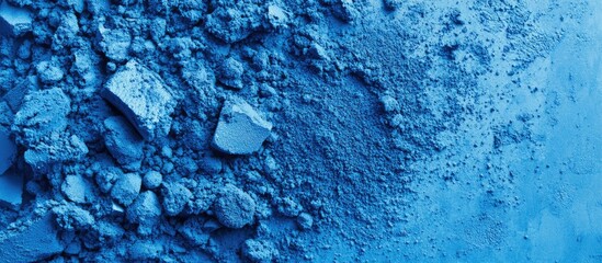 Poster - Vibrant blue powder texture background with varying shades and a modern aesthetic ideal for design applications, featuring granules in the lower left corner.