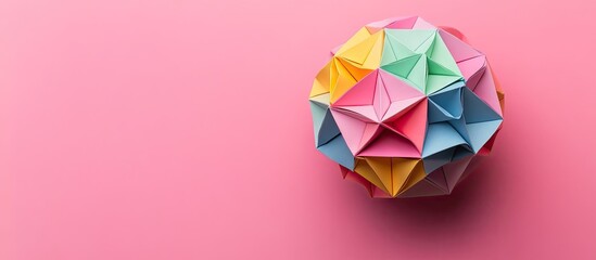 Poster - Colorful geometric paper shape on a soft pink background with sharp edges visible on red, blue, and yellow creating a vibrant visual contrast.