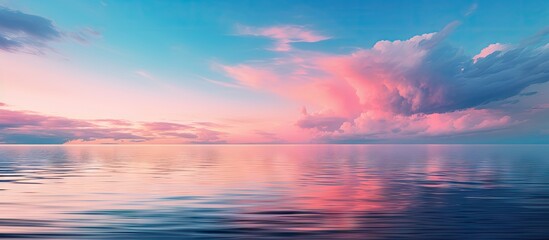 Poster - Twilight sky with soft pink and blue hues reflecting on calm sea surface creating a serene and tranquil atmosphere in the landscape image