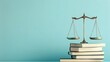 © Selvi - Golden Scales of Justice on Stack of Books Against Light Blue Background