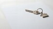© buggal1406 - Metal keys with house-shaped keychain on blank document background with copy space