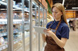 © pressmaster - Waist up portrait of young woman working in supermarket and using tablet for stock managements, copy space