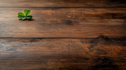 Poster - A delicate green clover rests on a weathered wooden board, highlighted by natural light, creating soft shadows and inviting warmth to the rustic setting
