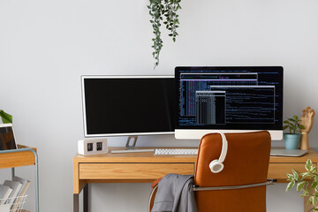 Wall Mural - programmer's workplace with computer monitors in light office