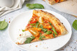 © Pixel-Shot - Slice of tasty pizza with Burrata cheese on grey background