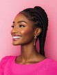 © Surachetsh - A glowing African American woman with braided hair and large earrings shines gracefully against an orange pink background.