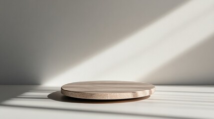 Fototapete - Sleek stone podium with smooth edges sits on a beige surface, casting a soft shadow, offering an ideal setup for showcasing products with copy space