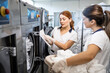 © littlewolf1989 - Female employees working together in laundry dry cleaning service.