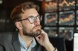 © Analogue - Thoughtful Businessman Analyzing Financial Data in Modern Office Environment with Graphs and Charts in Background