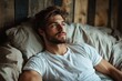 © Andrii - Relaxed man gazing thoughtfully in cozy room