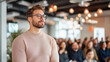© Number One Studio - Man with glasses listening attentively in modern conference setting, surrounded by engaged audience. atmosphere is focused and inspiring