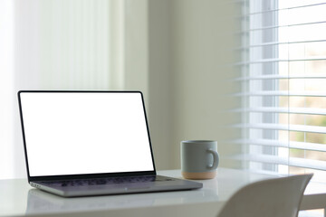 Wall Mural - minimalist home office with laptop and coffee cup.