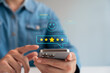 © Thapana_Studio - Customer satisfaction survey, consumers use smartphones via online applications to rate 5 stars for excellent service and product quality, increasing business credibility and reputation.