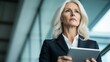 © Phatcharee - Professional businesswoman analyzing data with tablet in modern office