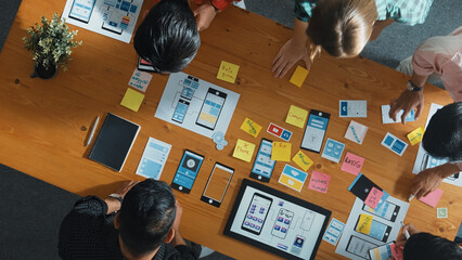 Wall Mural - top view of software developer team looking ux ui design for mobile phone interface from tablet whil