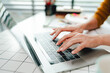© Dino - Typing on keyboard Working online on laptop computer On a white table at the office. Facebook chat. Web meeting. Blogger. Journalist writing an article. online job ideas