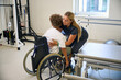 © Svitlana - Therapist guides a patient through a safe transfer from wheelchair