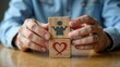 © Katti - Handmade arrangement of wooden blocks with medical icons. Healthcare and insurance concept. Male doctor hands holding blocks. Close-up