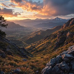 Fototapete - A breathtaking sunset over a valley nestled between rugged mountains, with a lone tree standing tall on the left. The sky is painted in a palette of oranges, pinks, and purples, while the ground is do