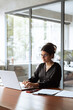 © Stock 4 You - Vertical portrait middle eastern woman using computer technology app for work online.Focused professional financial it specialist latin hispanic business lady working on laptop pc sitting in office
