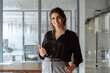 © Stock 4 You - Portrait of middle eastern businesswoman using tablet pc app for work standing at office. Smiling indian or hispanic CEO business woman manager specialist holding digital computer, looking at camera