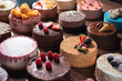© venars.original - Many cakes are placed on the table next to each other, each cake has a different color and different decoration