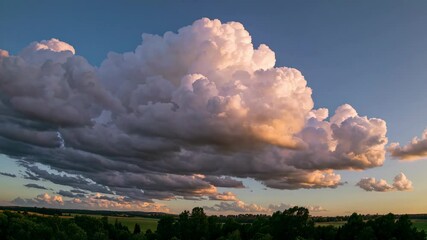 Wall Mural - Dramatic sunset clouds over green landscape, vibrant colors. Nature scenery concept