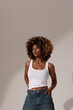 © face_reader_img - Beautiful African American woman with curly hairstyle wears casual clothing.. Vertical.