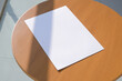 © dark_blade - paper a4 mockup design. blank paper poster mockup on wooden coffee table , shadow overlay