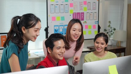 Wall Mural - asian web designers team discussing user interface design on desktop computer