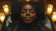 © Julia - A peaceful spa ambiance showcases a Black woman getting a soothing massage, with candles casting a soft light and essential oils scenting the air