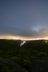 Wall Mural - Cloudy landscape of tree and river at dawn.