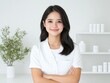 © darion - A professional woman in a white uniform stands confidently in a modern clinic with skincare products on display