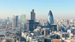 © PengAI - A panoramic view of London's skyline featuring modern skyscrapers like The Shard and the Gherkin against a clear blue sky.