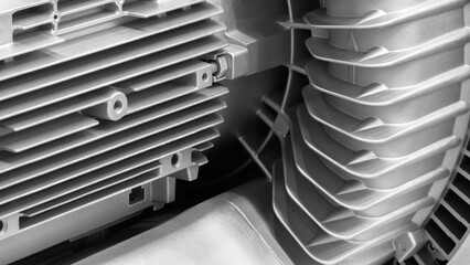 Aufkleber - A close-up of an electric machine with a silver ribbed surface. The machine has many metal parts and is very shiny.