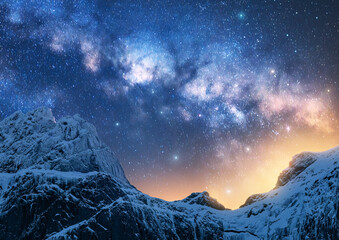 Wall Mural - glowing milky way over the beautiful mountains with snow covered peak at night in winter colorful la