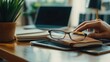 © Johannes - designer hand working with. digital tablet and laptop and notebook stack and eye glass on wooden desk in office