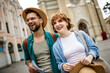 © Mediteraneo - Young couple using a map to explore the new city on their vacation.