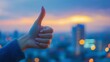 © Jane Kelly - Beautiful woman's hand giving thumbs up over blurred city background with copy space
