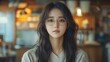 © QuietWord - Asian young pretty woman in leisure wool shirt looking at camera sitting at cozy modern working space room