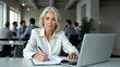 © Родион Бондаренко - Portrait of mature businesswoman writing in notebook with thoughtful look while working in office