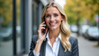 © Galeno - businesswoman smiles taking phone call outside professional setting