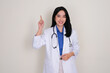 © KrishnaTedjo - A young female doctor smiling happy while pointing above her