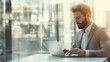© Adobe Contributor - Businessman Working on Laptop by Window