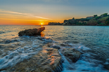 Wall Mural - beautiful sunrise on the wild, rocky bay of zakynthos island