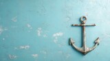 This visually attractive photograph showcases an antique anchor leaning against a textured blue wall, inviting thoughts of maritime adventure and nostalgia.