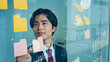 © metamorworks - プランを練るビジネスマンと統計データイメージ